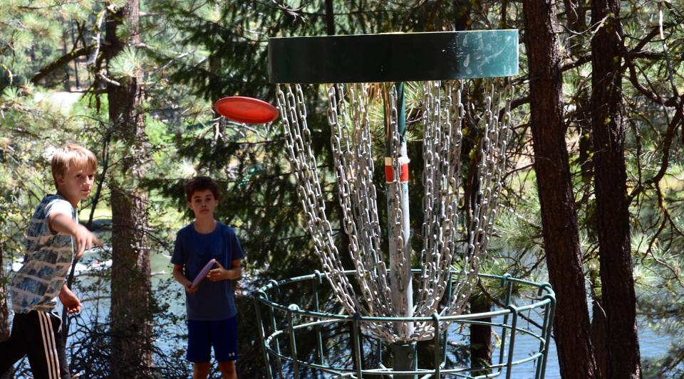 boys throws disc towards basket