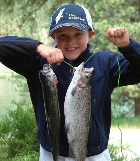 young boy holding fish
