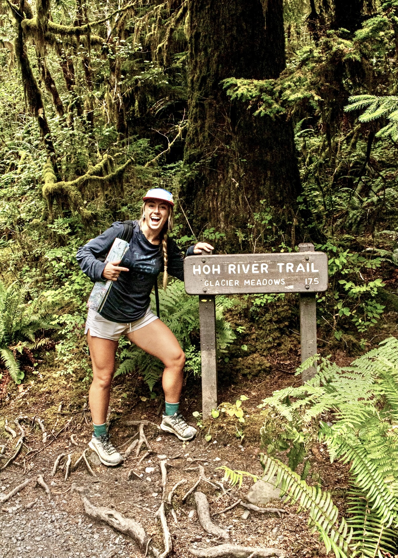 Miranda at a trailhead marker